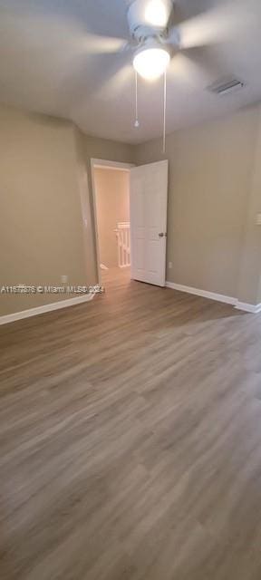 spare room featuring hardwood / wood-style floors and ceiling fan