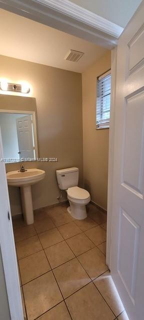 bathroom featuring toilet and tile patterned floors