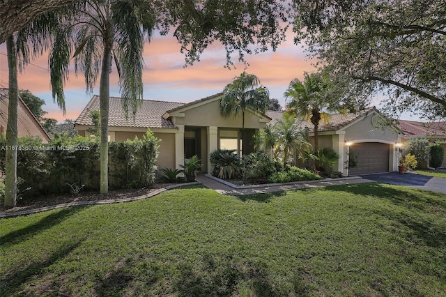 view of front of property with a lawn and a garage