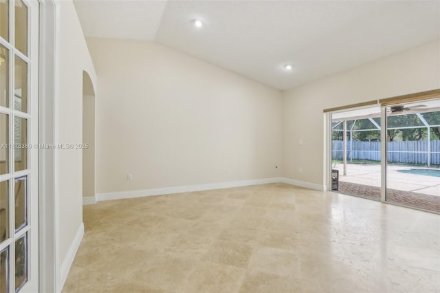 unfurnished room featuring vaulted ceiling