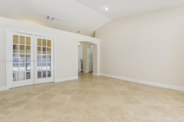 spare room featuring french doors and lofted ceiling