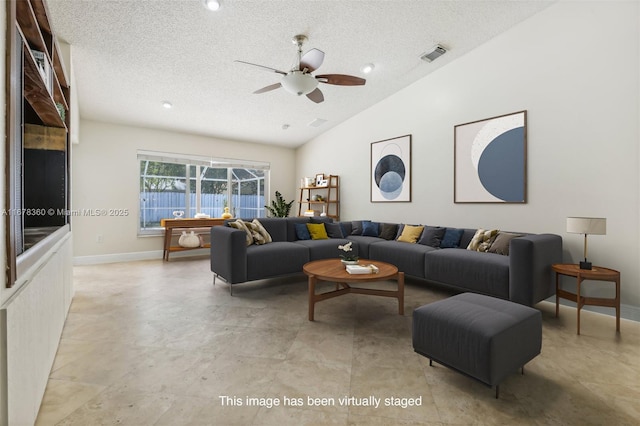 living room with a textured ceiling, ceiling fan, and lofted ceiling