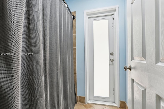 bathroom featuring tile patterned floors and curtained shower