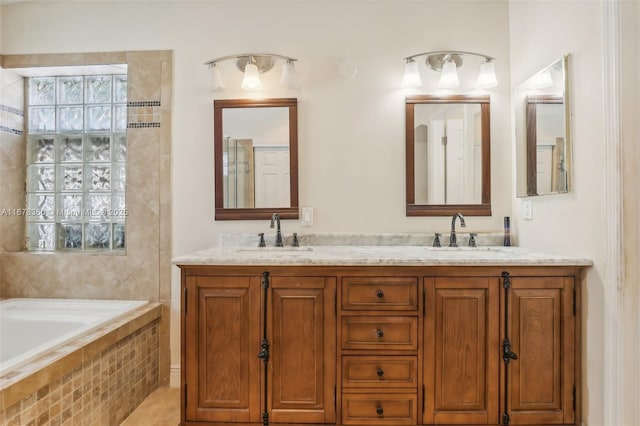 bathroom with vanity and tiled bath