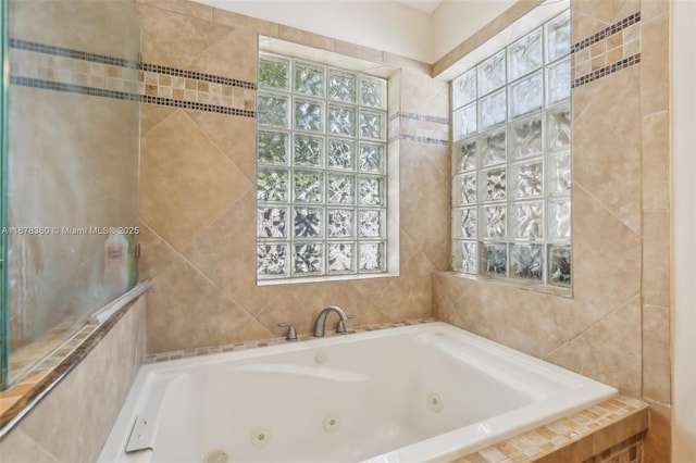 bathroom with a relaxing tiled tub