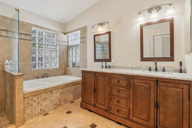 bathroom with tile patterned floors, vanity, and independent shower and bath