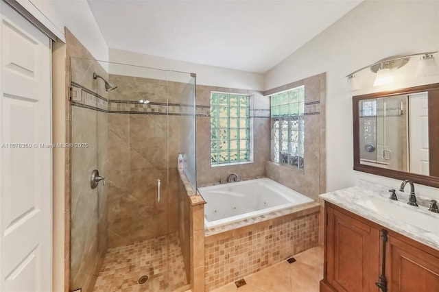 bathroom featuring tile patterned flooring, vanity, lofted ceiling, and plus walk in shower