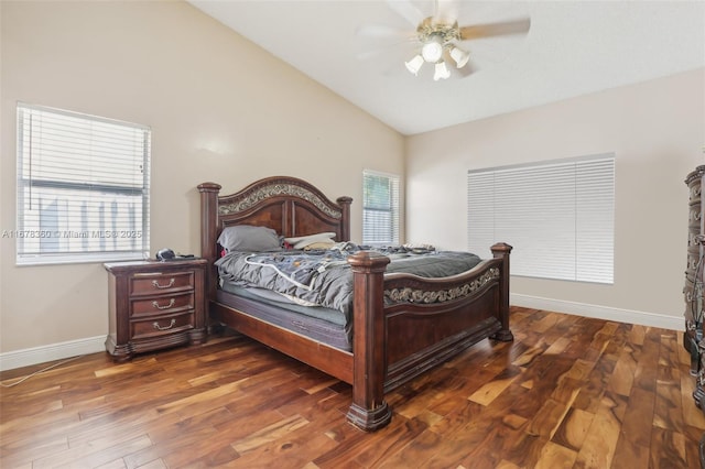 bedroom with ceiling fan, dark wood-type flooring, and vaulted ceiling