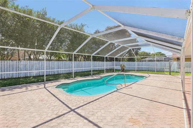 view of swimming pool with a lanai and a patio area