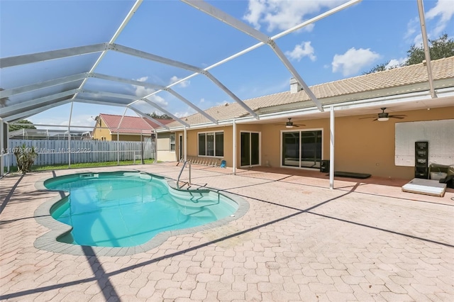 view of pool featuring ceiling fan, a patio, and glass enclosure