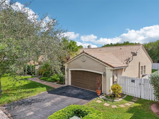 view of front of property with a garage and a front lawn