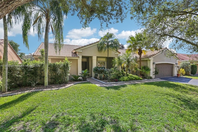 view of front of house featuring a front yard and a garage