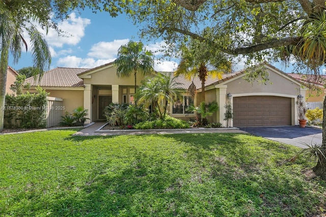 view of front of home featuring a garage and a front lawn