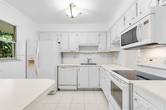 kitchen featuring white appliances, light tile patterned floors, sink, and white cabinets