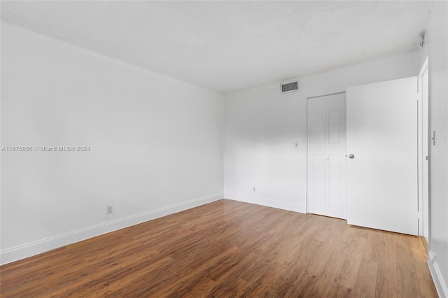 unfurnished bedroom featuring a closet and light hardwood / wood-style floors