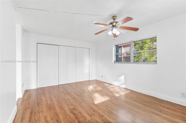 unfurnished bedroom featuring a closet, ceiling fan, and hardwood / wood-style floors