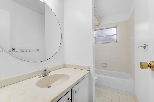 full bathroom with tiled shower / bath, vanity, toilet, and tile patterned floors