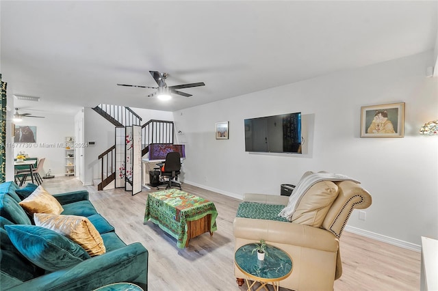 living room with light wood-type flooring and ceiling fan