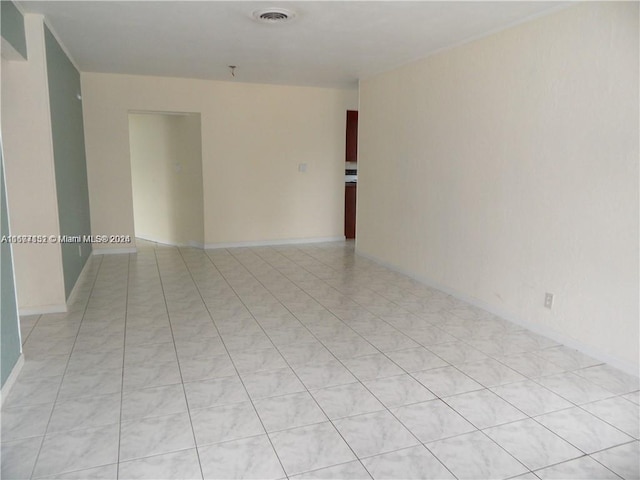 spare room featuring light tile patterned flooring