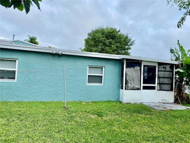 view of side of property with a lawn