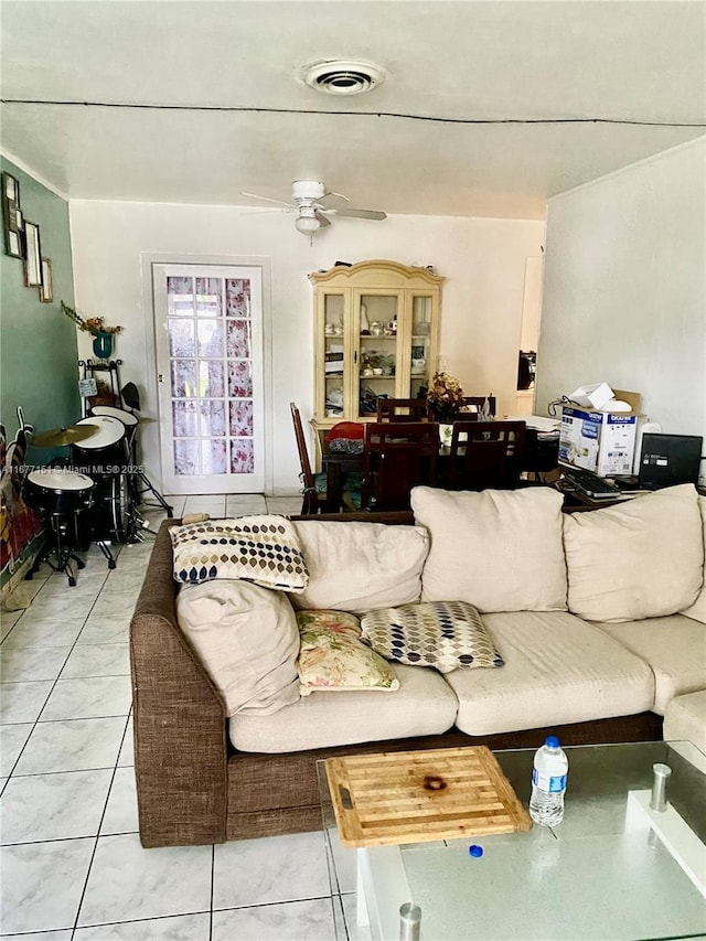 tiled living room featuring ceiling fan