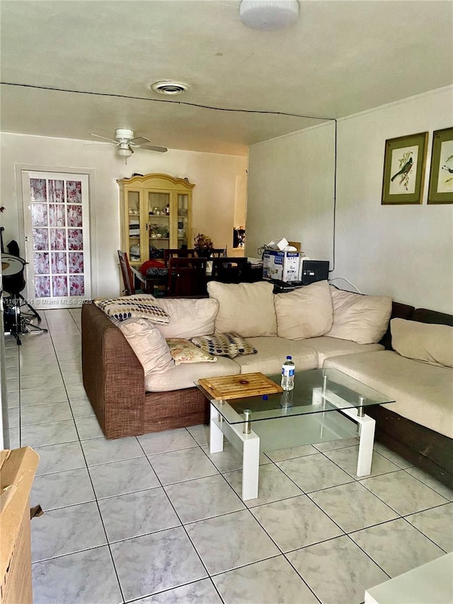 tiled living room featuring ceiling fan