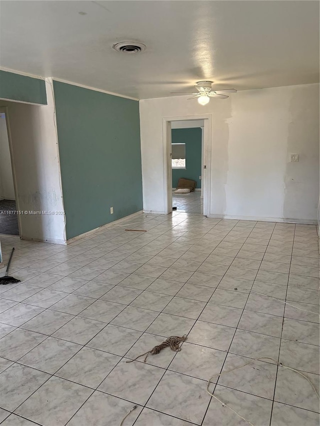 spare room with light tile patterned flooring, ceiling fan, and ornamental molding