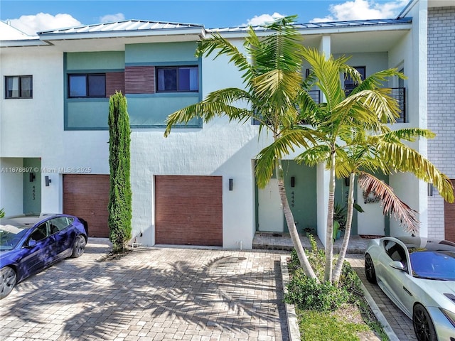 multi unit property featuring a garage