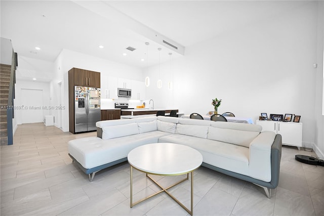 living room with sink and a towering ceiling