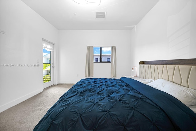 carpeted bedroom featuring access to exterior and multiple windows