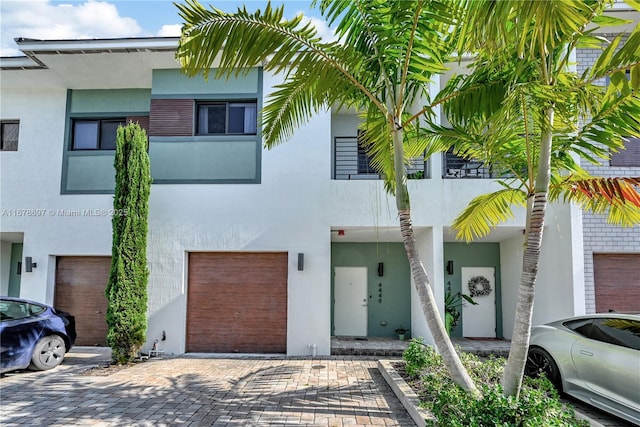 view of property featuring a garage and a balcony