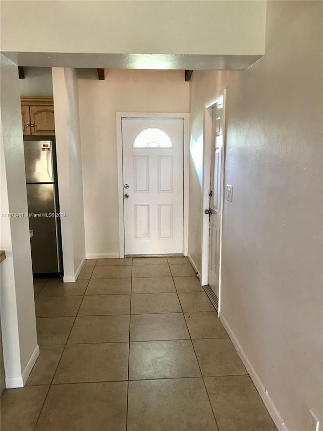 doorway to outside featuring dark tile patterned flooring