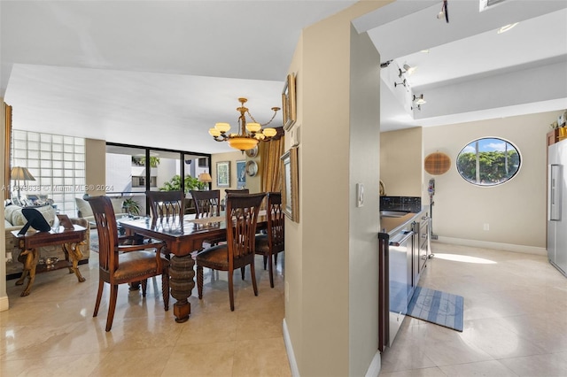 dining area with an inviting chandelier and sink