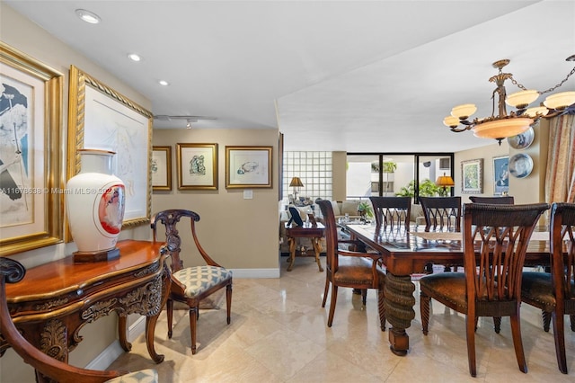 dining area with a notable chandelier and rail lighting