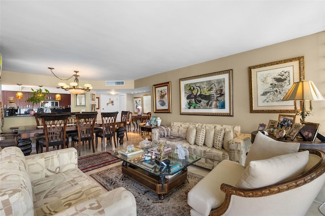 living room with hardwood / wood-style flooring and an inviting chandelier