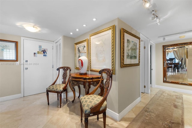 tiled dining area featuring rail lighting