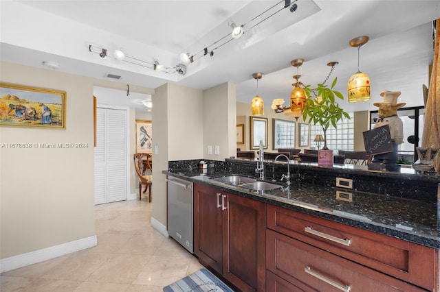 kitchen with sink, decorative light fixtures, dishwasher, and dark stone countertops