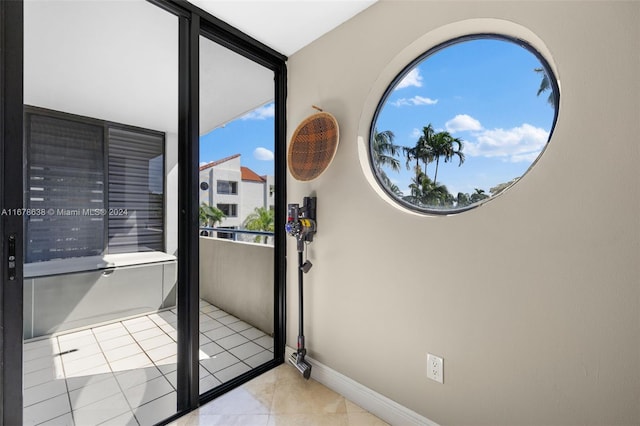 doorway with light tile patterned flooring