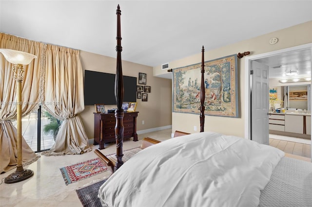 tiled bedroom featuring ensuite bath and access to exterior