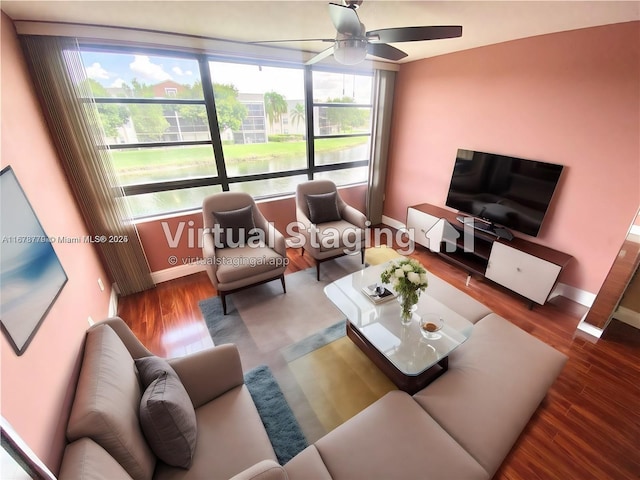 living room featuring ceiling fan and wood-type flooring