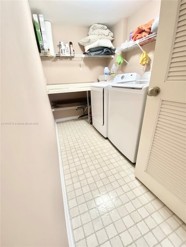 clothes washing area with washing machine and clothes dryer