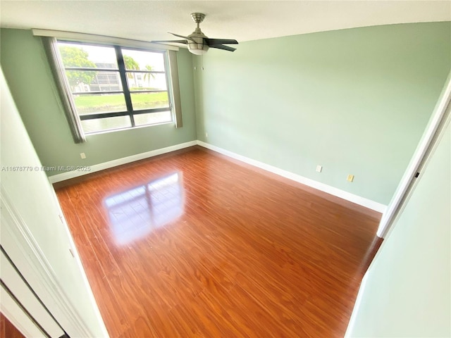 unfurnished room with hardwood / wood-style flooring and ceiling fan