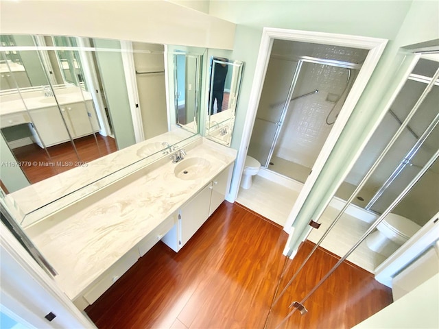 bathroom featuring wood-type flooring, toilet, and walk in shower