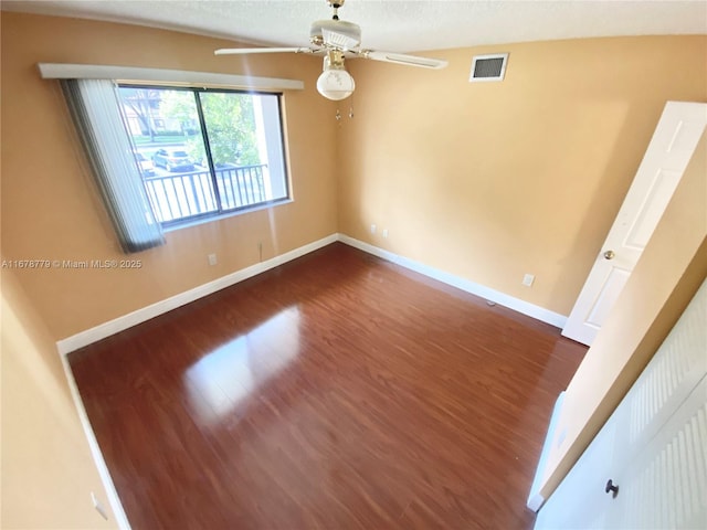 empty room with ceiling fan and dark wood-type flooring