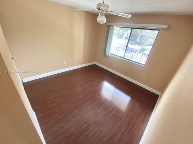 unfurnished room featuring ceiling fan and dark hardwood / wood-style flooring