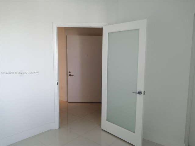 hallway with light tile patterned floors