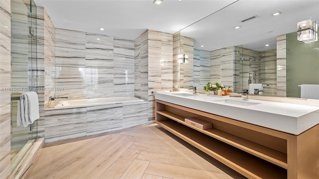 bathroom featuring vanity, separate shower and tub, and tile walls