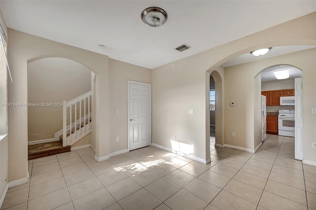 unfurnished room with light tile patterned floors