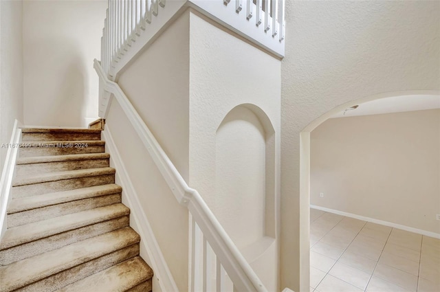 staircase with tile patterned flooring