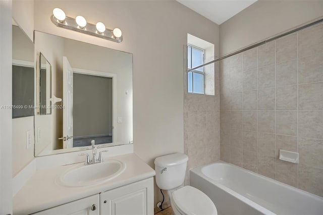 full bathroom with vanity, toilet, and tiled shower / bath